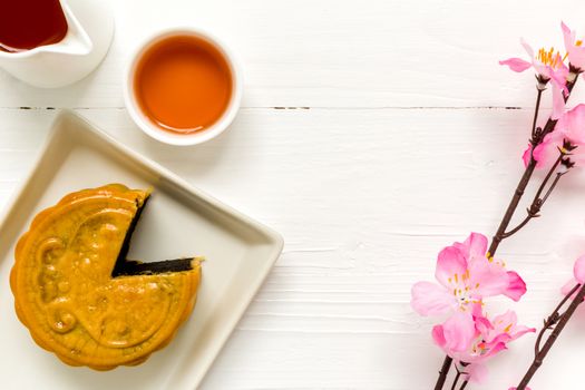 Traditional Chinese mooncake eaten with hot tea for relaxing time.