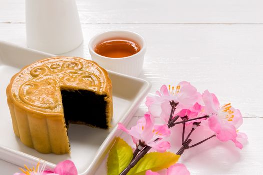 Traditional Chinese mooncake eaten with hot tea for relaxing time.