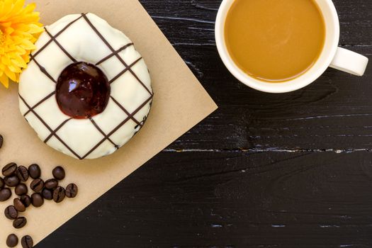 Fresh donut or doughnut with cup of hot coffee for relaxing moment.