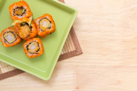 Traditional Japanese food, sushi roll, on wooden background