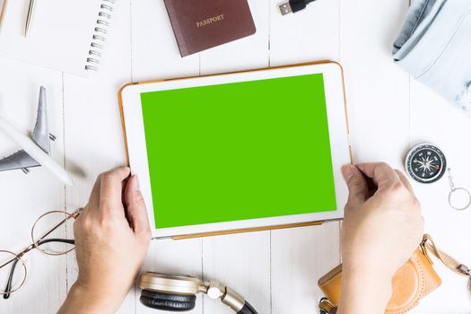 Traveler is picking tablet with blank screen for mobile application mock up