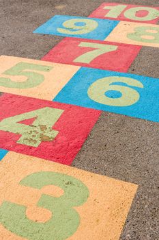 Colorful hop scotch game for children on playground.