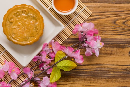 Traditional Chinese mooncake eaten with hot tea for relaxing time.