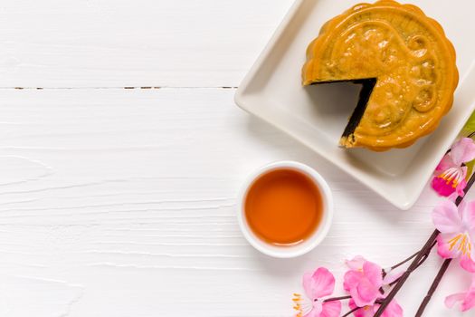 Traditional Chinese mooncake eaten with hot tea for relaxing time.