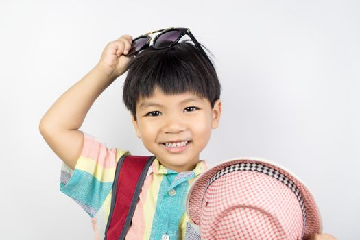 Asian kid is getting dressed up in summer clothing for summer Vacation isolated on white