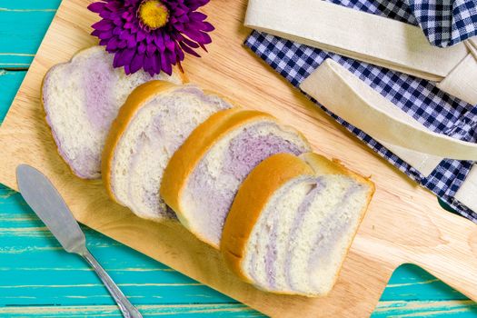 Taro bread for breakfast on vintage wooden background.