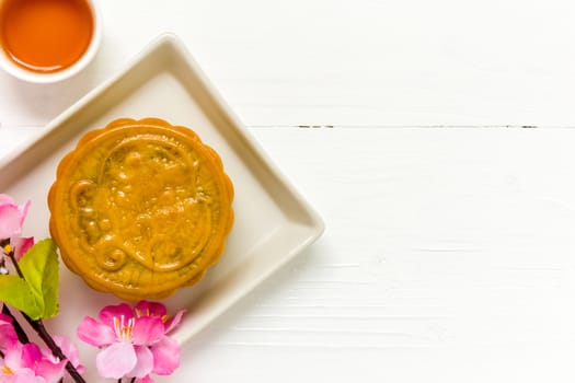 Traditional Chinese mooncake eaten with hot tea for relaxing time.