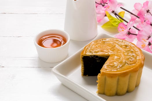 Traditional Chinese mooncake eaten with hot tea for relaxing time.