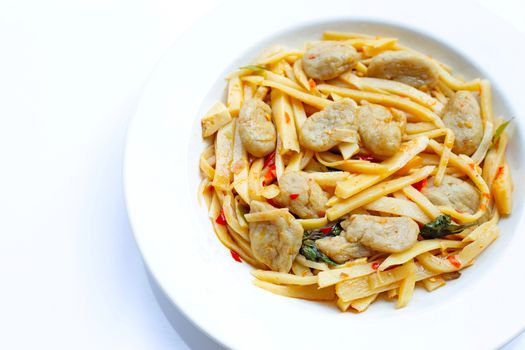 Spicy preserved bamboo shoot stir fried recipe with fish ball on white background. Copy space