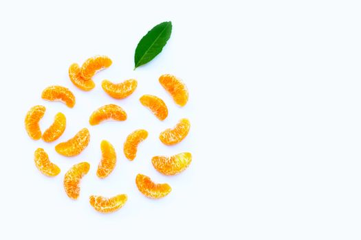 Orange segments with leaf on white background.  Copy  space