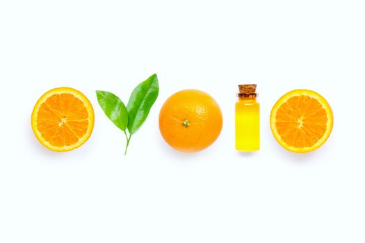 Natural citrus oil with fresh orange fruit and green leaves  on white background. High vitamin C. Copy space