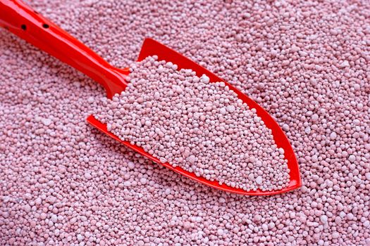Chemical plant fertilizer with garden trowel for planting and plantation.