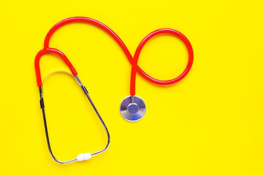 Stethoscope on yellow background. copy space