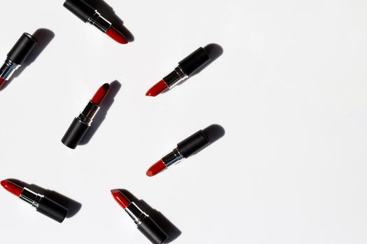 Flat lay composition, Lipsticks on white background with shadow. Beautiful Make-up concept
