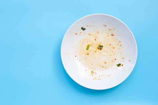 Dirty dish on blue background. Top view