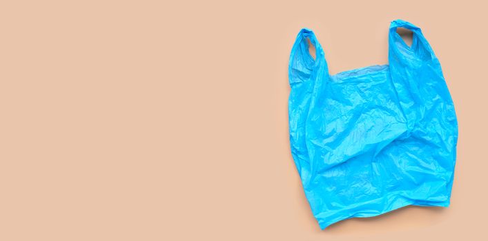 Blue plastic bag on browm background. Copy space