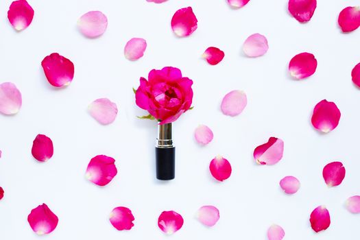 Lipstick with rose petals isolated on white background.