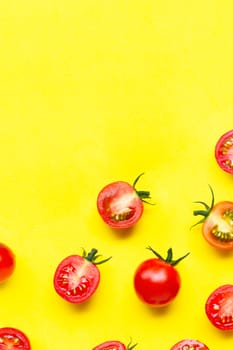 Fresh tomatoes, whole and half cut isolated on yellow background. Top view