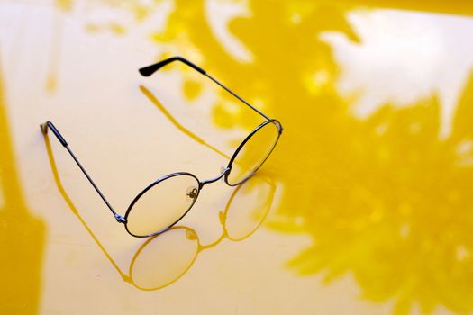 Eye Glasses on yellow background. Copy space