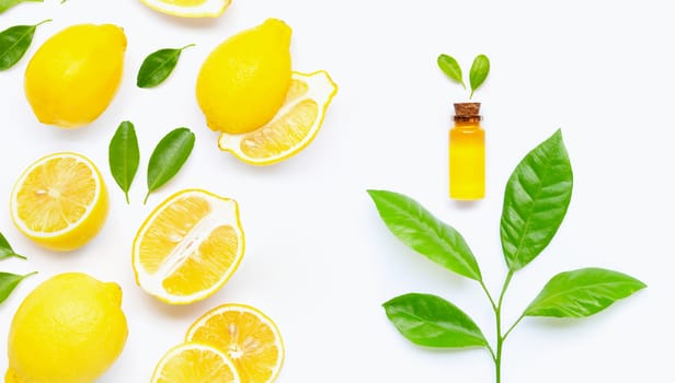 Natural oil with lemon and citrus green leaves on white background. High vitamin C.