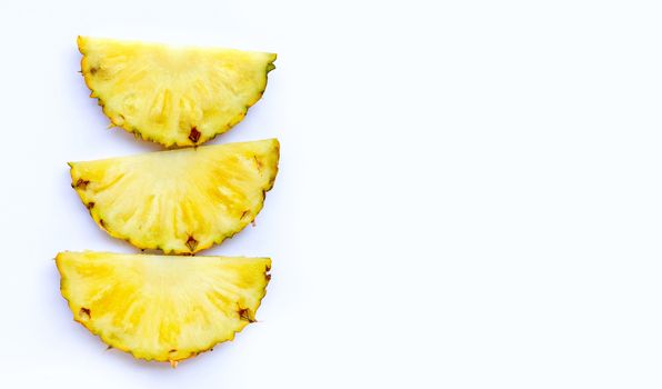 Fresh pineapple slices on white background. Copy space