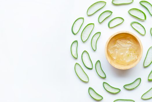 Aloe vera slices with aloe vera gel in wooden bowl on white background. Copy space