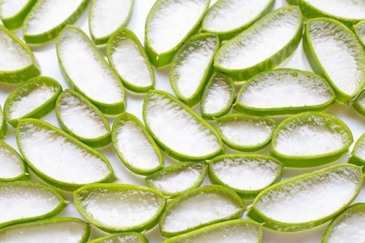 Aloe vera slices on white background.
