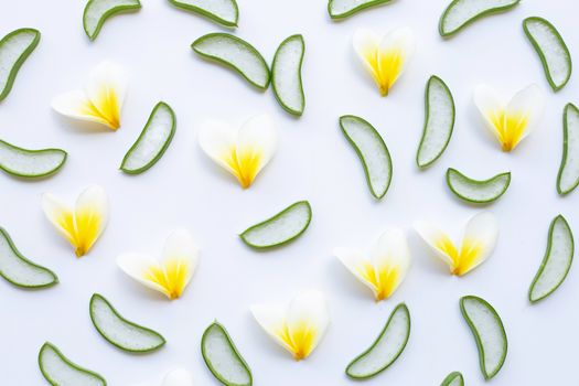 Aloe vera slices and Plumeria flower on white background