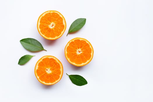 Fresh orange citrus fruits with leaves on white background.  Top view with copy space