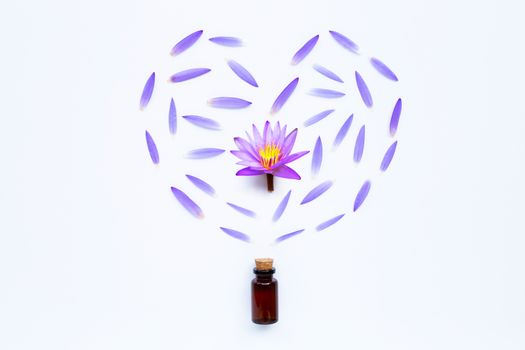 Essential oil with Purple lotus flower on white background.