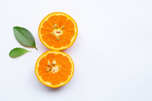 Orange fruit with green leaves on white background. Copy space