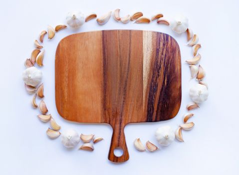 Garlic with wooden cutting board on white background