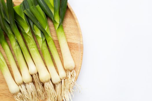 Young green garlic on white background