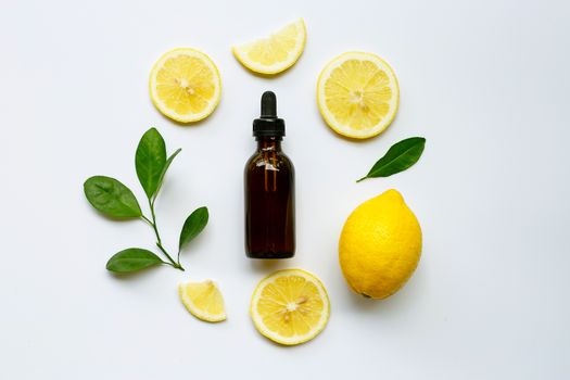 Fresh lemon with lemon essential oil on a white background.