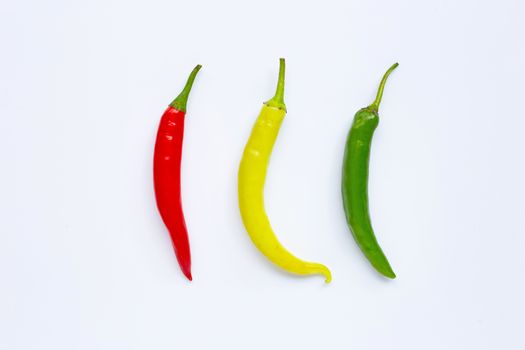Different colors chili peppers isolated on white background