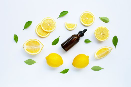 Fresh lemon with lemon essential oil on a white background.