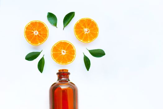 High vitamin C, Orange fruits with essential oil bottle on white background. Copy spae