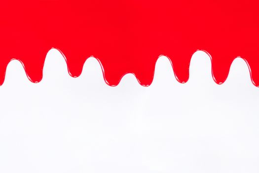 Red paint dripping on a white background