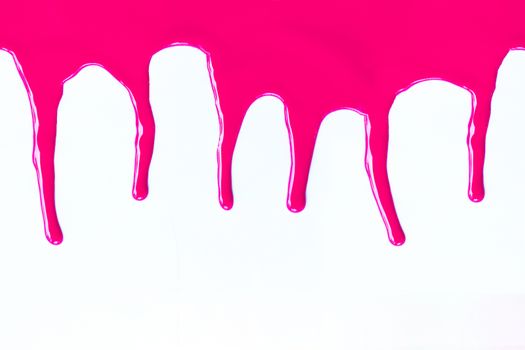 Pink paint dripping on a white background