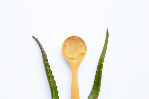 Aloe vera gel on wooden spoon with aloe vera on white background.