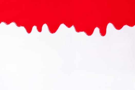 Red paint dripping on a white background