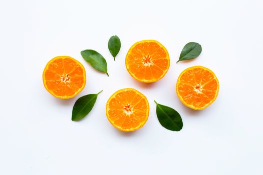 Orange fruits with leaves on white background. Top view