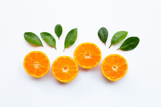Orange fruits with leaves on white background. Top view