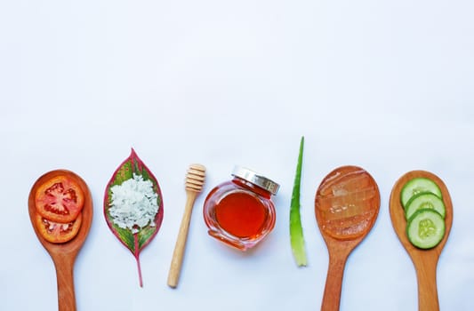 Natural ingredients for homemade skin care on white background.