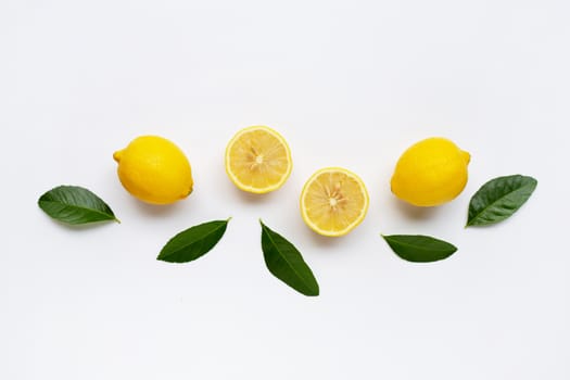 Lemon and slices with green leaves isolated on white background.