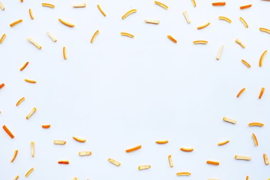 Frame made of orange peels on white background. top view