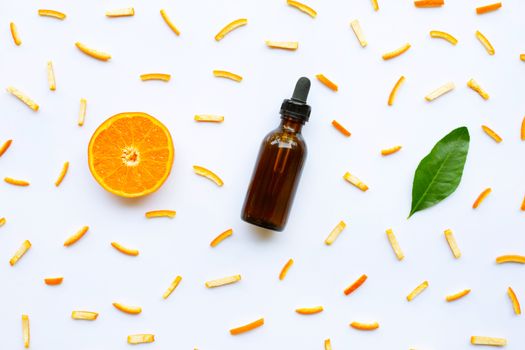 Essential oils with citrus fruits on white background.