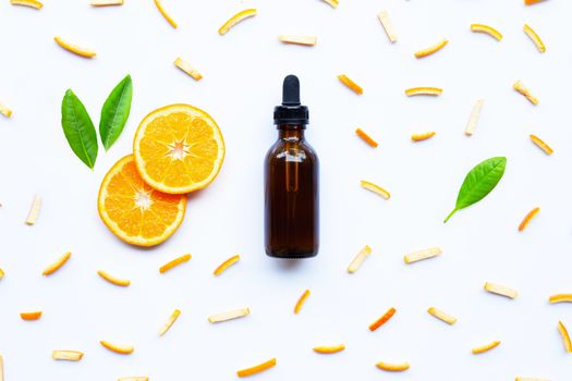 Essential oil with citrus fruits on white background.
