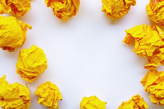 Yellow crumpled paper ball isolated on white background. Copy space