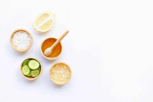 Natural ingredients for homemade skin care on white.